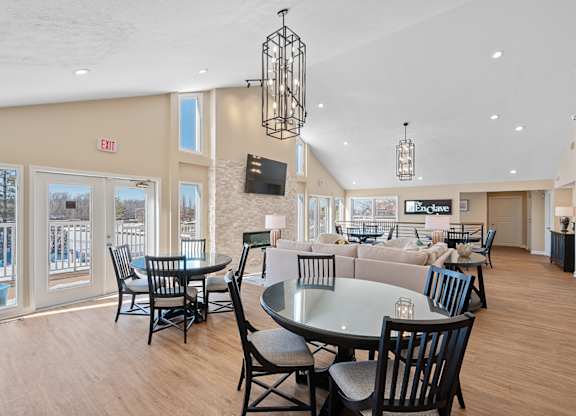 A dining area with a glass table surrounded by chairs at Enclave, Beavercreek