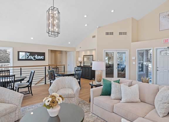 A living room with a couch, chairs, and a table with a vase of flowers on it at Enclave, Beavercreek, OH, 45431