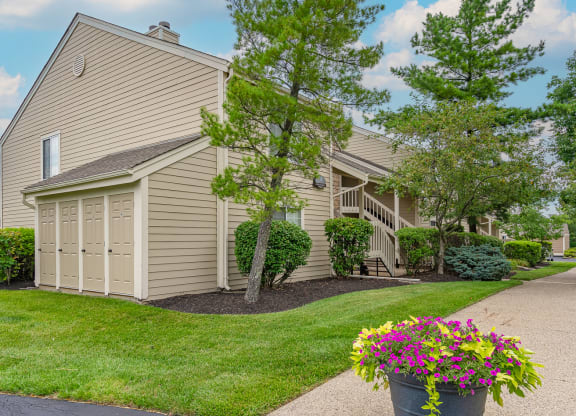 a house with a garage and a driveway with a potted plant on the side of the at Enclave, Beavercreek