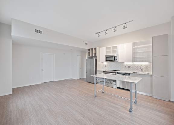 A kitchen area with a table and a microwave at Sky Central Apartments, Ohio
