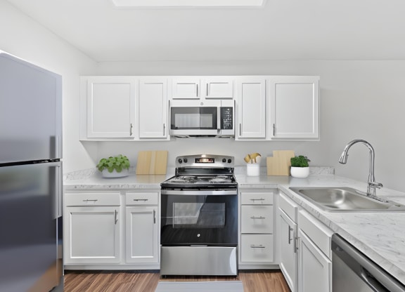 a kitchen with white cabinets and stainless steel appliances