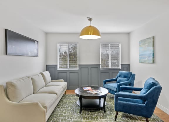 Living room with a white couch and two blue chairs at The Valley, Cincinnati, Ohio
