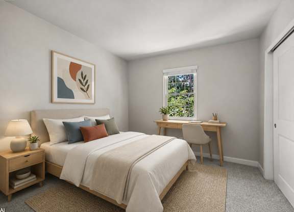 A bedroom with a bed, desk, chair, and lamp.