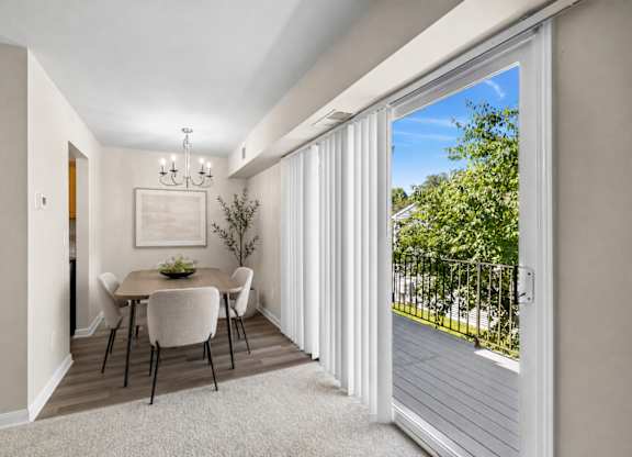 A dining room with a table set for four.