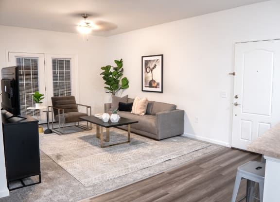 a living room with a couch coffee table and a tv  at Waterstone Landing, Perrysburg, 43551