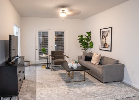 a living room with a couch chair coffee table and tv  at Waterstone Landing, Perrysburg, OH
