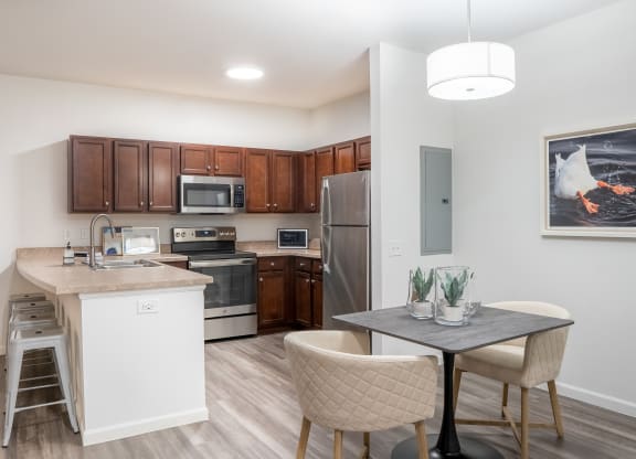 a kitchen and dining area in a 555 waverly unit  at Waterstone Landing, Perrysburg, OH, 43551