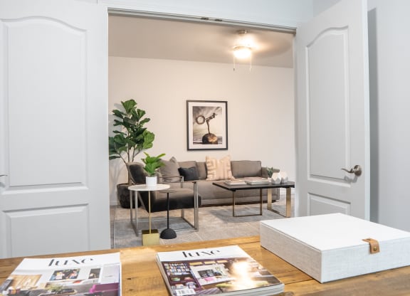 a living room with white walls and a wooden table at Waterstone Landing, Perrysburg, Ohio