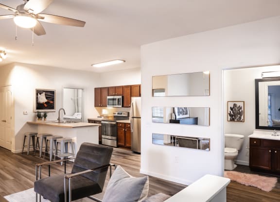 a living room with a couch and a chair and a kitchen with a sink and a toilet at Waterstone Landing, Perrysburg