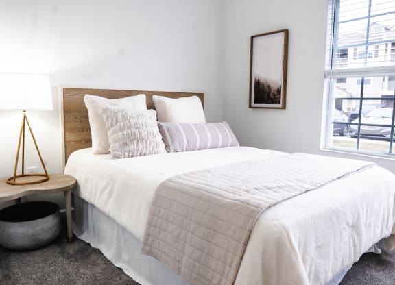 a bedroom with a bed and a window  at Waterstone Landing, Ohio