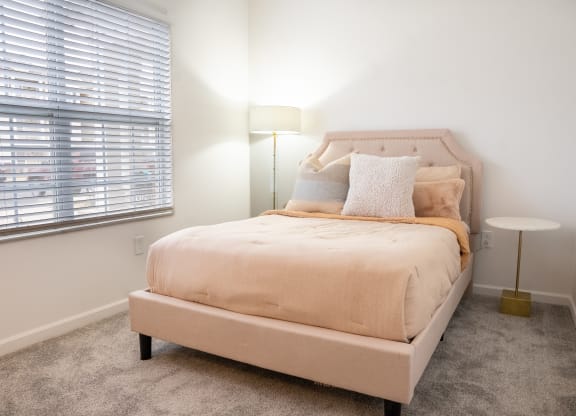 a bedroom with a bed and two windows  at Waterstone Landing, Perrysburg