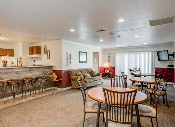 a living room and dining room with a table and chairs