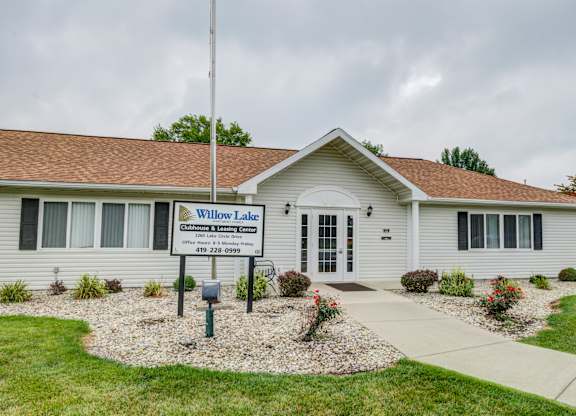 a white building with a sign in front of it