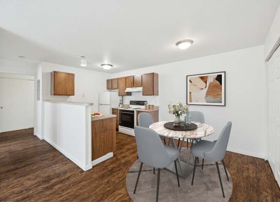 A kitchen with a table and chairs in the middle of the room.