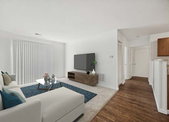 A modern living room with a white sofa and a television.