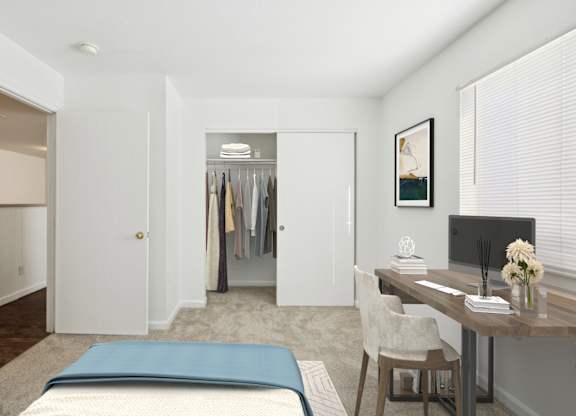 A bedroom with a bed, desk, and closet.