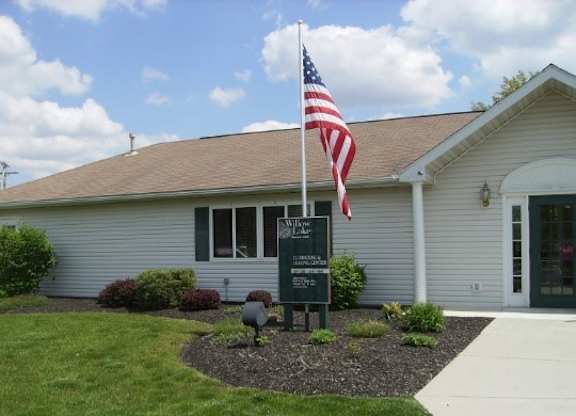 a white building with an flag in front of it