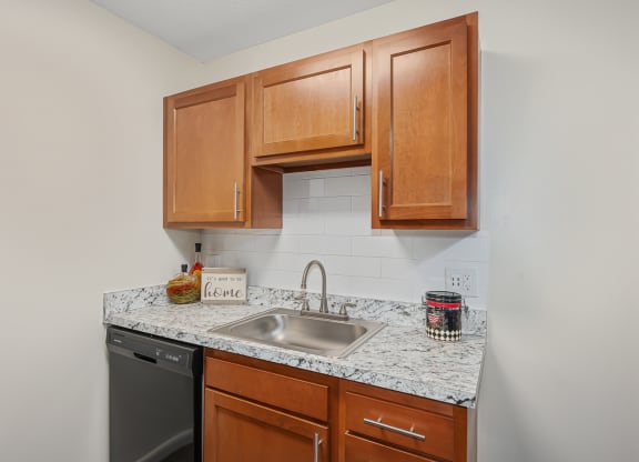 a kitchen with wood cabinets and granite countertops at The Woodridge Collection, Fairfield, 45014