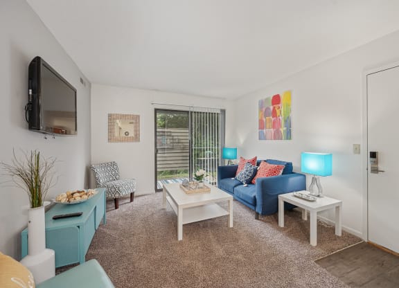 a living room with white walls and a blue couch at The Woodridge Collection, Ohio, 45014