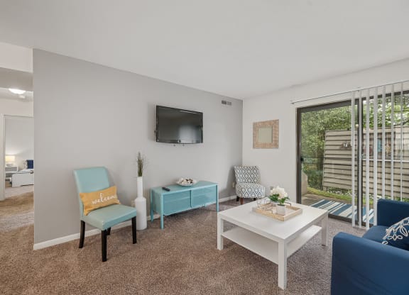 our apartments offer a living room with a couch coffee table and tv at The Woodridge Collection, Ohio