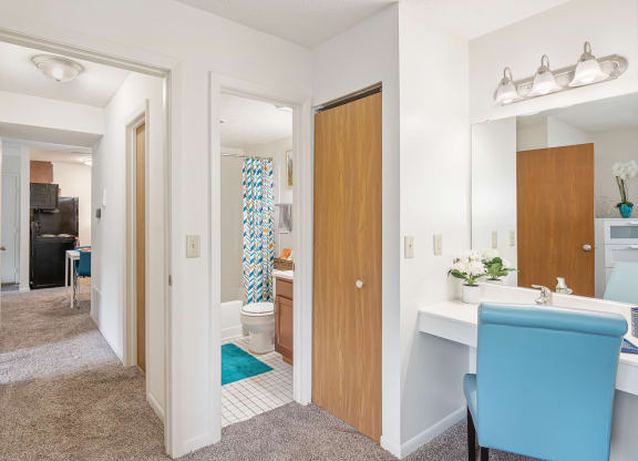 a hallway with two doors and a blue chair at The Woodridge Collection, Fairfield