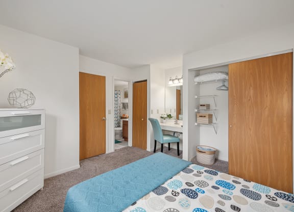 a bedroom with a bed and a desk in a room  at The Woodridge Collection, Fairfield, OH 45014