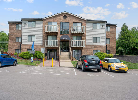 a large apartment building with a parking lot in front of it at The Woodridge Collection, Fairfield Ohio