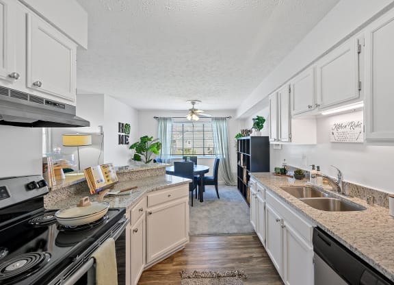 Spacious kitchen with granite counter tops and a dining room with a table and chairs at Wrights Point, 41011