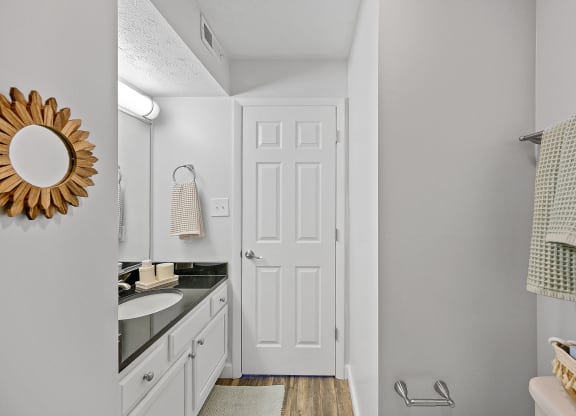 Bathroom with a white door and a sink and a mirror at Wrights Point, Ft Wright