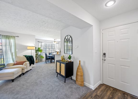 Open living room and dining room with a white door at Wrights Point, Ft Wright, KY