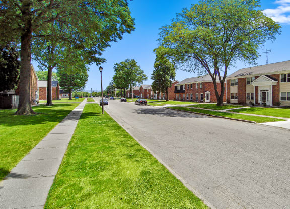 A street view of a residential area with houses on both sides.