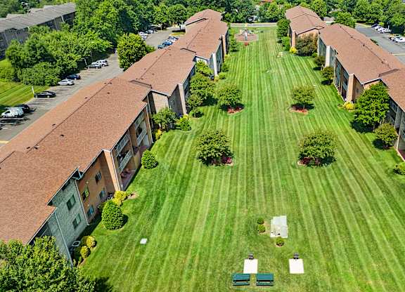 an aerial view of an apartment complex with a green lawn at Gainsborough Court Apartments, Fairfax