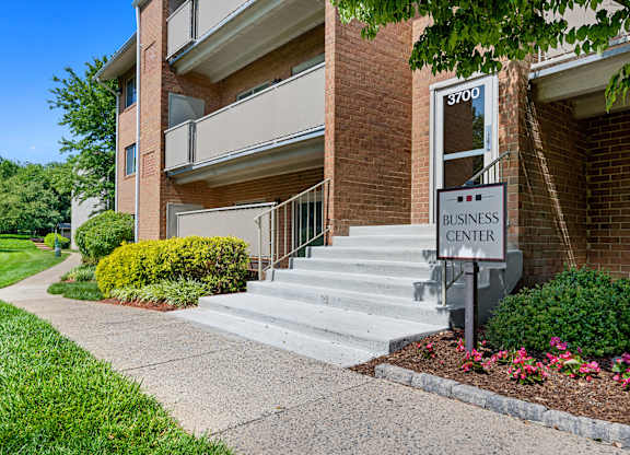 a business center sign in front of a brick building at Gainsborough Court Apartments, Fairfax, Virginia
