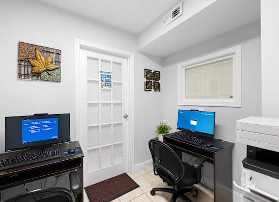 a home office with two computers and a printer at Gainsborough Court Apartments, Fairfax, VA, 22030