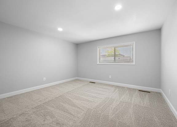 an empty room with white walls and a window on the wall at Gainsborough Court Apartments, Fairfax, VA, 22030