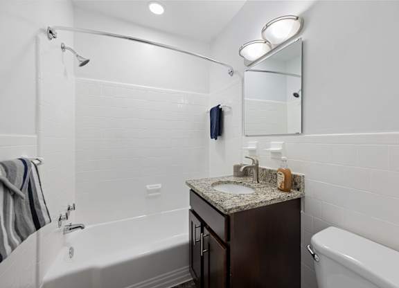 a bathroom with a sink and a bath tub and a shower at Gainsborough Court Apartments, Virginia, 22030