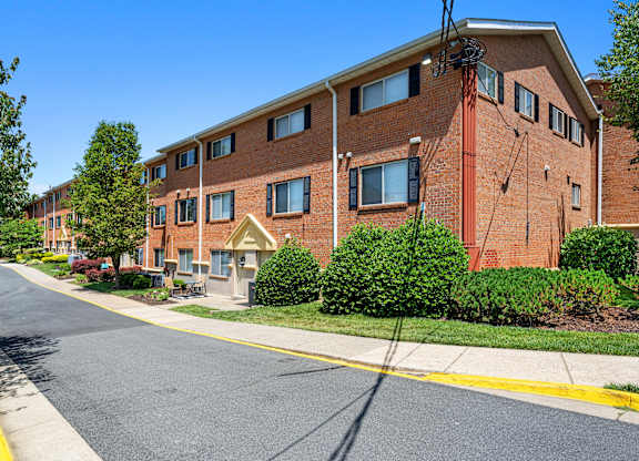 a brick apartment building with a street in front of it at Gainsborough Court Apartments, Fairfax, 22030