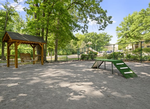 a picnic area with a picnic table and a bench in a park