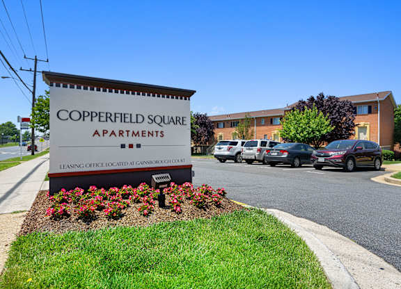 a sign for copperfield square apartments in front of a parking lot at Gainsborough Court Apartments, Fairfax
