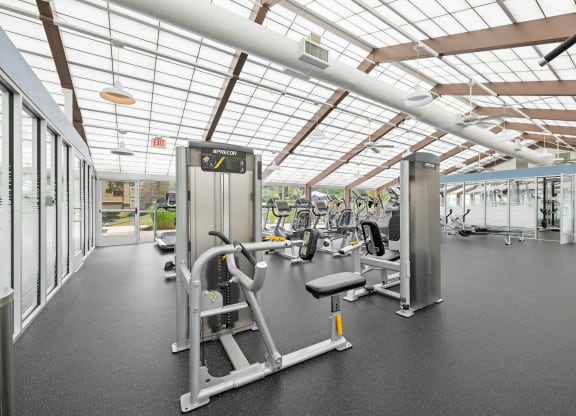 a gym with weights and cardio equipment and glass ceilings