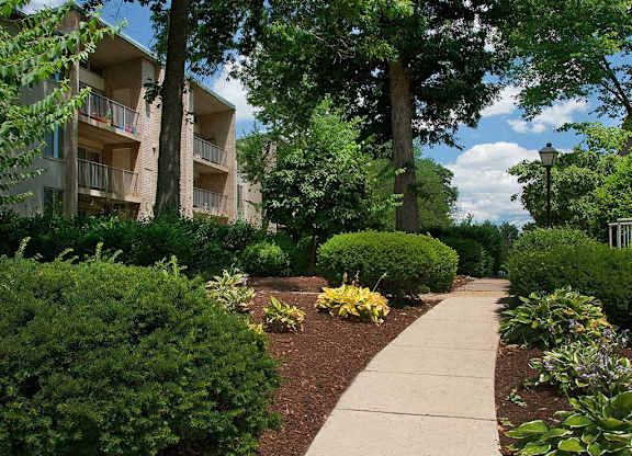 Walkway with lush green landscaping at Tysons Glen Apartments and Townhomes, Virginia