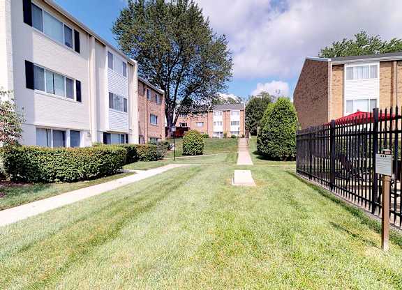 Green grass area with cornhole area at Tysons Glen Apartments and Townhomes, Falls Church, Virginia