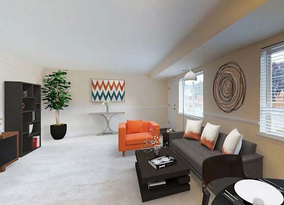 A living room with a grey couch, a white coffee table, and a green plant at Gainsborough Court Apartments, Fairfax