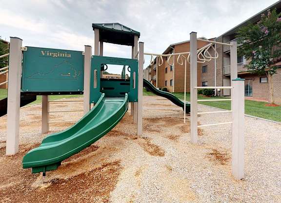 A playground with a green slide and a Virginia sign at Gainsborough Court Apartments, Fairfax, VA, 22030