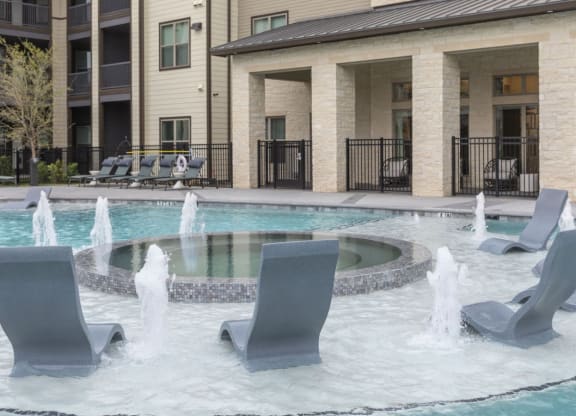 Resort-Style Pool with Grilling Area, Tanning Ledges, Cabanas & Hot Tub at The Bridge at McKinney