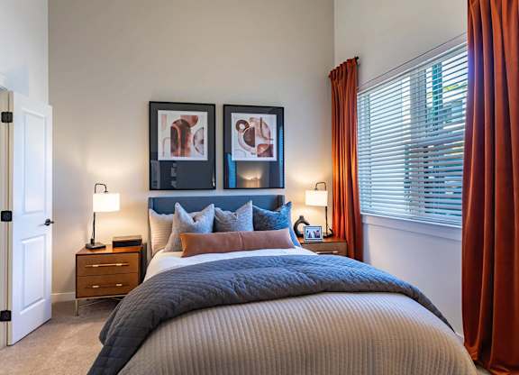 a bedroom with a bed and a windowat Sterling Nashville West Apartments, Tennessee, 37209