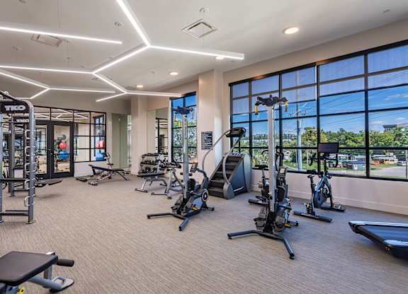 a gym with weights and cardio equipment and large windowsat Sterling Nashville West Apartments, Nashville, 37209
