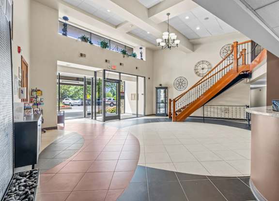 A foyer with a staircase and a chandelier.