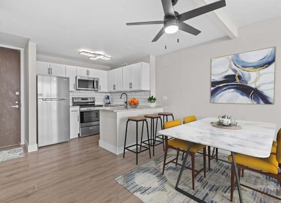 A modern kitchen with a dining table and chairs.