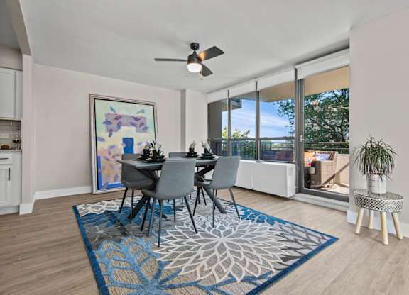 A dining room with a table set for four.